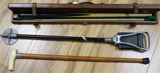 An ivory and silver handled cane, a leather cased snooker cue and a shooting stick
